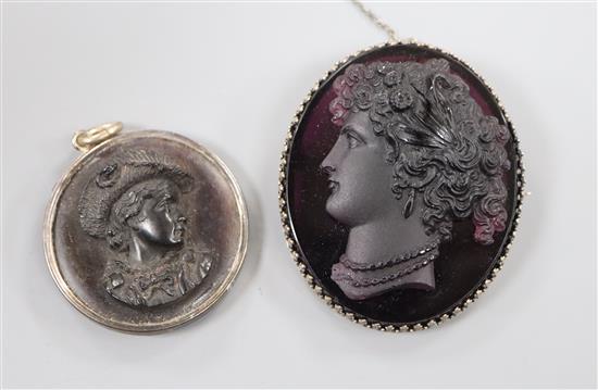A metal mounted amethyst paste cameo carved with the bust of a lady to dexter and a tortoiseshell cameo, largest 58mm.